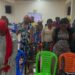 Women at Conquering Tabernacle Ministry International standing in prayer during a faith-driven workshop organized by A New Day Advocacy to support Liberia’s drug-affected youth and families