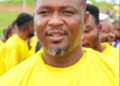 A community figure in a yellow shirt speaks at a public event in Nimba County