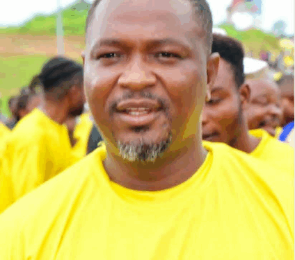 A community figure in a yellow shirt speaks at a public event in Nimba County
