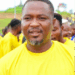 A community figure in a yellow shirt speaks at a public event in Nimba County