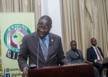 A man in a suit speaking at a podium during a regional anti-money laundering forum