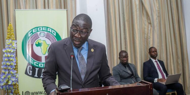 A man in a suit speaking at a podium during a regional anti-money laundering forum