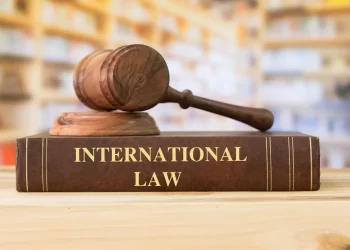 Liberia international law article illustration showing a wooden gavel on a book titled International Law