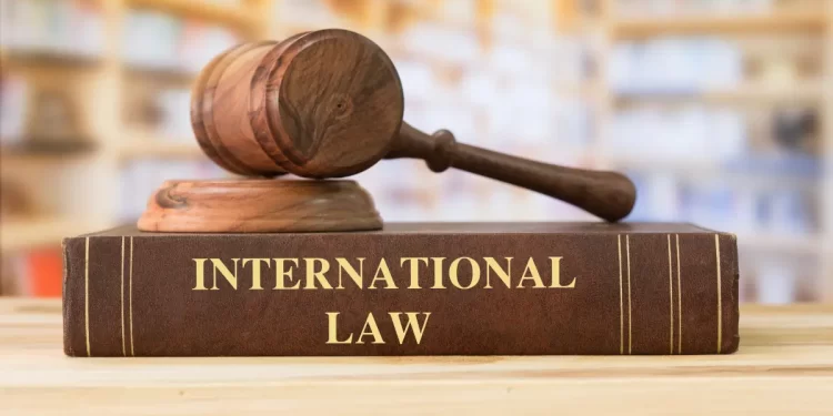 Liberia international law article illustration showing a wooden gavel on a book titled International Law
