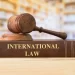 Liberia international law article illustration showing a wooden gavel on a book titled International Law