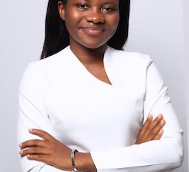 Alphia Faith Kemokai, Liberian youth advocate and Program Manager of YPLS Africa, poses in a white outfit after being selected for the Obama Foundation’s 2025 Leaders Africa Program.