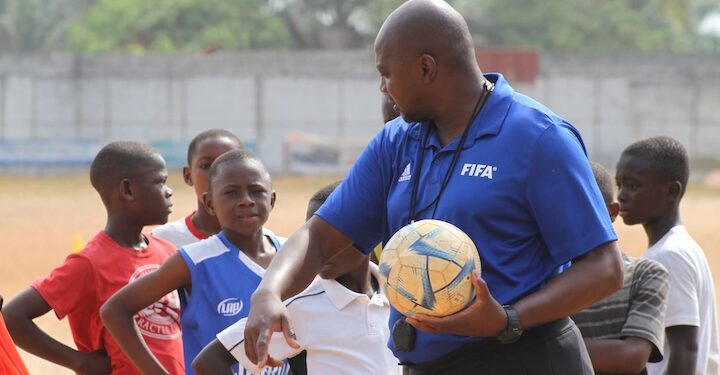 FIFA Talent Coach Ammy Ninje instructs young Liberian footballers during a youth training session in Monrovia