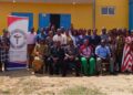 A group of people gathered in front of a building during a nursing and midwifery conference event