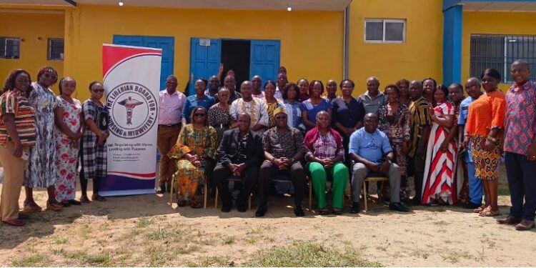 A group of people gathered in front of a building during a nursing and midwifery conference event