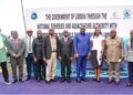 A group of people standing together at an outdoor commissioning ceremony for a national fisheries project