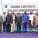 A group of people standing together at an outdoor commissioning ceremony for a national fisheries project