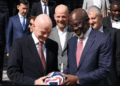 George Weah receives a football from FIFA President Gianni Infantino during a panel session on ending racism in football in Rabat, Morocco.