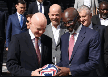 George Weah receives a football from FIFA President Gianni Infantino during a panel session on ending racism in football in Rabat, Morocco.