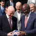 George Weah receives a football from FIFA President Gianni Infantino during a panel session on ending racism in football in Rabat, Morocco.