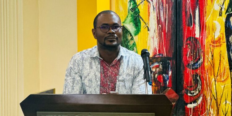 Dominic T. Johns, Team Lead of Champions for Change, delivers remarks at the Liberia National Forest Forum 2025 at the Cape Hotel in Monrovia.
