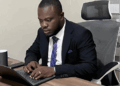 William Telebo Thompson working on a laptop after being appointed Global President of the International Chess Polytechnic