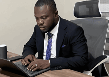 William Telebo Thompson working on a laptop after being appointed Global President of the International Chess Polytechnic