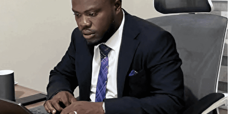 William Telebo Thompson working on a laptop after being appointed Global President of the International Chess Polytechnic