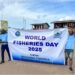 Two participants hold a banner reading “World Fisheries Day 2025” during Liberia’s first-ever national celebration.