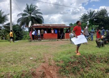 Protesters in Yarpah Town hold placards demanding financial accountability in River Cess County.