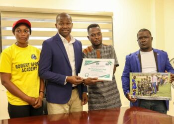 LFA President Mustapha Raji receives honor from Roberts Sports Academy for supporting grassroots football in Liberia.