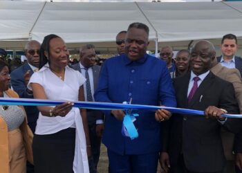 Vice President Jeremiah Koung cuts ribbon during launch of Liberia’s first semi-industrial fishing vessel