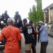Police escorting defendants into a pickup truck outside the Temple of Justice following a contempt ruling related to a Supreme Court-ordered eviction in Paynesville.