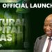 President Joseph Boakai smiling next to the official launch banner of the Natural Capital Atlas of Liberia.