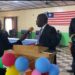 Chief Justice Yamie Quiqui Gbeisay administers an oath during a court ceremony in Kakata, Margibi County, as officers and dignitaries look on under the Liberian flag