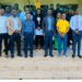 A group of journalists and officials standing together after a professional training workshop.