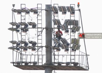 Technicians install new floodlights at the SKD Sports Complex during the renovation works.