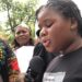 A young Liberian girl reads a petition during a protest in Monrovia calling on the UN to intervene in rising sexual violence cases.