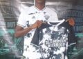 A Black Man Warriors player holds up the retired No. 2 jersey in honor of late defender Amara Kamara.