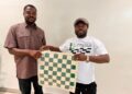 ICP President William Telebo Thompson presenting chess equipment to Ghana Chess Association representative in Accra.