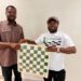 ICP President William Telebo Thompson presenting chess equipment to Ghana Chess Association representative in Accra.