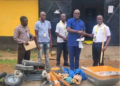 Harper City Mayor Abraham Jackson receives sanitation tools from LPRC representatives, including wheelbarrows, shovels and cutlasses, to support the city’s cleanup campaign