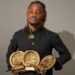Liberian artist King Dennis holding multiple MLMA 2025 award trophies after winning major categories.
