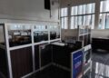 Liberia News Agency newsroom showing empty cubicles, damaged furniture, and inactive workstations, reflecting the declining operational state described by staff.
