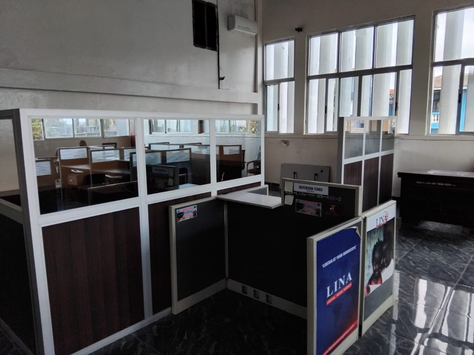 Liberia News Agency newsroom showing empty cubicles, damaged furniture, and inactive workstations, reflecting the declining operational state described by staff.