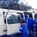 Members of Liberia’s amputee football team boarding a crowded commercial bus with luggage tied on the roof after returning from a tournament.