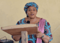 Education Minister Dr. Jarso Jallah speaking at a podium during the launch of Liberia’s Girls’ Education Scorecard.