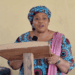 Education Minister Dr. Jarso Jallah speaking at a podium during the launch of Liberia’s Girls’ Education Scorecard.