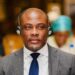 Rep. Taa Z. K. Wongbe seated at a conference wearing headphones and a suit during an ECOWAS Parliamentary session