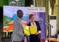 A Liberian official and a French Development Agency representative hold signed cooperation documents during the launch of the €9M WISE forest conservation initiative.