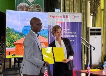 A Liberian official and a French Development Agency representative hold signed cooperation documents during the launch of the €9M WISE forest conservation initiative.