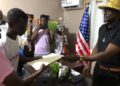 Anthony T. Cole hands over legal documents of the Zenna Hill Estate to family members during a formal ceremony in Paynesville, Liberia