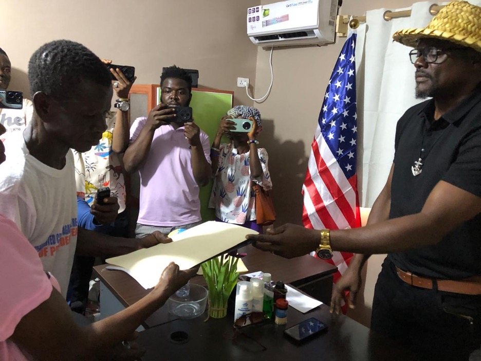 Anthony T. Cole hands over legal documents of the Zenna Hill Estate to family members during a formal ceremony in Paynesville, Liberia