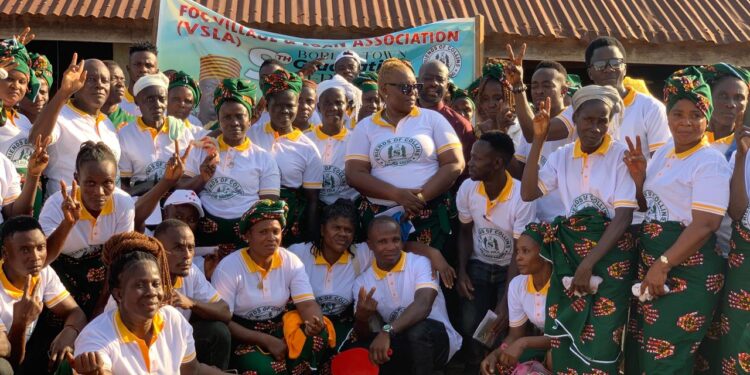 A large group of women from the Friends of Collins Village Savings Association in Borlia, Gbarpolu County, pose together during their 2024–2025 graduation ceremony after achieving an L$8 million savings milestone