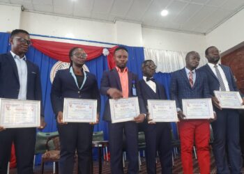 UL 105th Graduating Class leadership inductees holding certificates during inauguration ceremony in Monrovia.