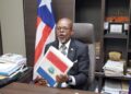 Sen. Darius Dillon holds the national budget during a press conference at his Capitol Hill office.